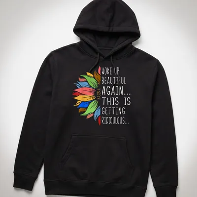 Humorous t-shirt with sunflower and vibrant text about waking up beautiful. — printed on a unisex hoodie