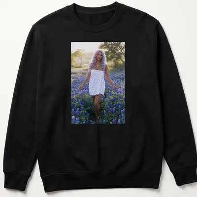 Photographic T-shirt featuring a woman in white dress among bluebonnet flowers — printed on a unisex sweatshirt