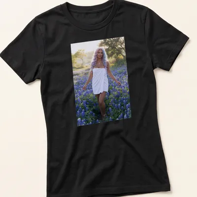 Photographic T-shirt featuring a woman in white dress among bluebonnet flowers — printed on a women's shirt