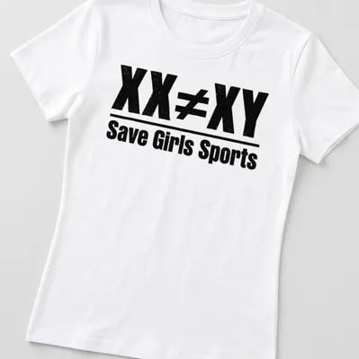 Bold distressed text graphic stating 'XX ≠ XY Save Girls Sports' in black and white — printed on a women's shirt