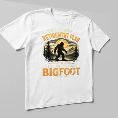 Funny retirement plan t-shirt featuring the text and Bigfoot illustration — printed on a unisex t-shirt (angled view)